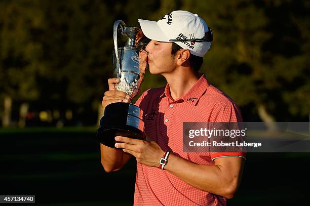 Sang-Moon Bae of South Korea kisses the champions trophy after winning the Frys.com Open at Silverado Resort and Spa on October 12, 2014 in Napa,...