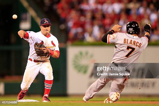 Gregor Blanco of the San Francisco Giants is out at second as Kolten Wong of the St. Louis Cardinals turns the double play on a ball hit by Joe Panik...