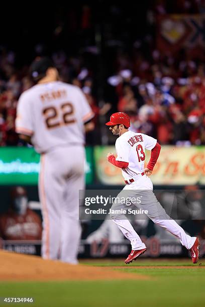 Matt Carpenter rounds the bases as Jake Peavy of the San Francisco Giants looks on after hitting a solo home run in the third inning during Game Two...