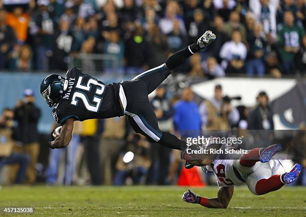 LeSean McCoy of the Philadelphia Eagles is hit by Antrel Rolle of the New York Giants after running for a first down during the first quarter in a...