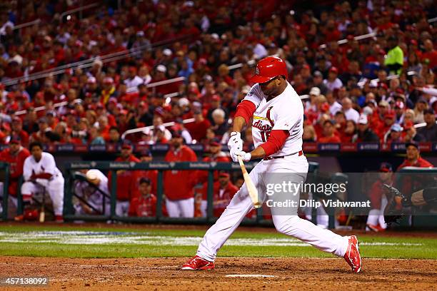 Oscar Taveras of the St. Louis Cardinals hits a solo home run in the seventh inning against the San Francisco Giants during Game Two of the National...