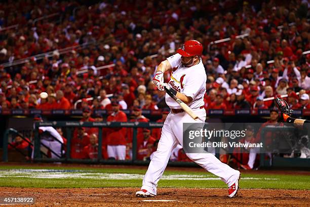 Matt Adams of the St. Louis Cardinals hits a solo home run in the eighth inning against the San Francisco Giants during Game Two of the National...