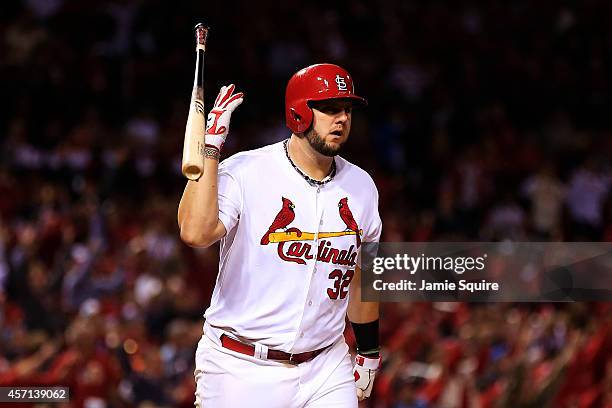 Matt Adams of the St. Louis Cardinals tosses his bat after hitting a solo home run in the eighth inning against the San Francisco Giants during Game...