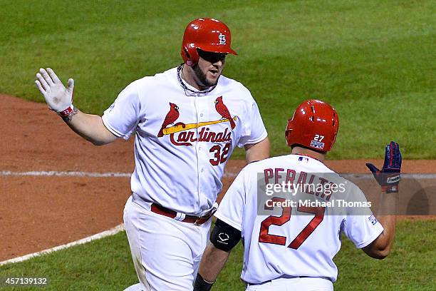 Matt Adams of the St. Louis Cardinals celebrates with Jhonny Peralta after hitting a solo home run in the eighth inning against the San Francisco...