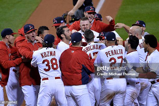 The St. Louis Cardinals celebrate their 5 to 4 win over the San Francisco Giants during Game Two of the National League Championship Series at Busch...
