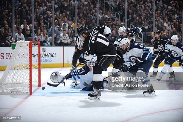 Anze Kopitar of the Los Angeles Kings scores against Michael Hutchinson of the Winnipeg Jets at STAPLES Center on September 12, 2014 in Los Angeles,...