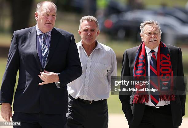 Bulldogs legend Doug Hawkins arrives with Demons legends Peter Keenan and Ron Barassi during a memorial service held for former Melbourne Demons VFL...