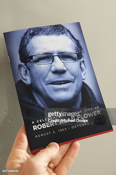 An image of Rob Flower is seen on the front of the service program during a memorial service held for former Melbourne Demons VFL player Robert...