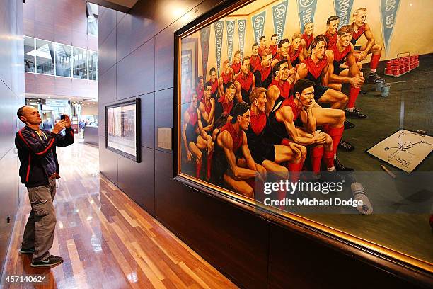 Member of the public takes a picture of Robert Flower in the Team Of The Century painting during a memorial service held for former Melbourne Demons...