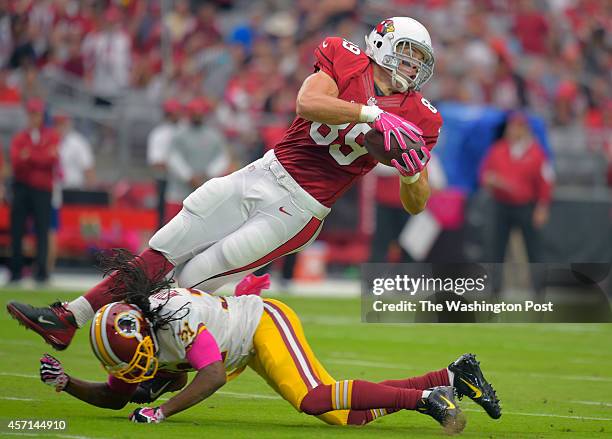 Arizona tight end John Carlson is upended by Washington strong safety Brandon Meriweather in the 4th quarter as the Arizona Cardinals defeat the...