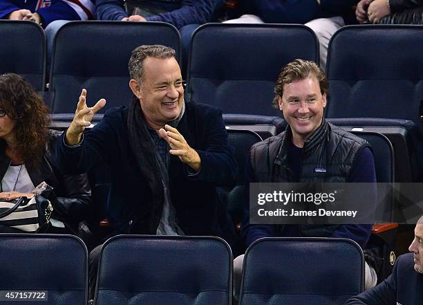 Tom Hanks and guest attend New York Rangers vs Toronto Maple Leafs game at Madison Square Garden on October 12, 2014 in New York City.