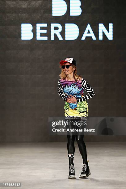 Fashion designer Deniz Berdan acknowledges the applause of the audience after the DB Berdan show during Mercedes Benz Fashion Week Istanbul SS15 at...