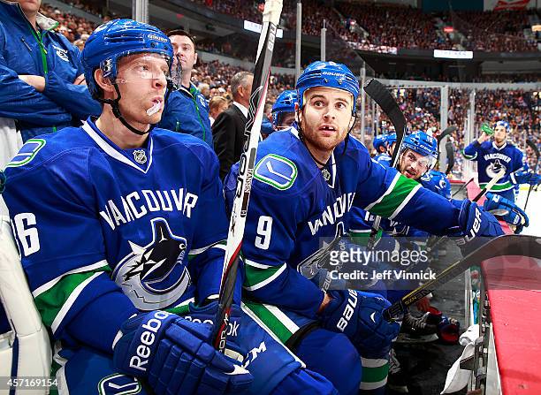 Jannik Hansen and Zack Kassian of the Vancouver Canucks look on from the bench during their NHL game against the Edmonton Oilers at Rogers Arena...