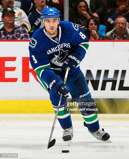 Christopher Tanev of the Vancouver Canucks skates up ice with the puck during their NHL game against the Edmonton Oilers at Rogers Arena October 11,...