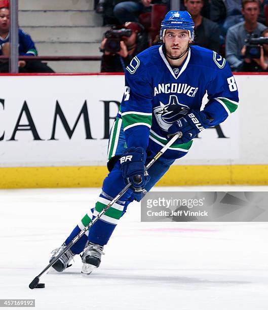 Christopher Tanev of the Vancouver Canucks skates up ice with the puck during their NHL game against the Edmonton Oilers at Rogers Arena October 11,...