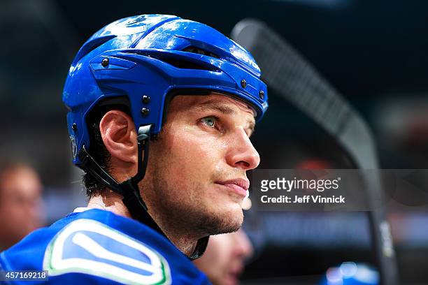 Kevin Bieksa of the Vancouver Canucks looks on from the bench during their NHL game against the Edmonton Oilers at Rogers Arena October 11, 2014 in...