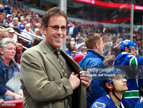 Assistant coach Doug Lidster of the Vancouver Canucks looks on from the bench during their NHL game against the Edmonton Oilers at Rogers Arena...