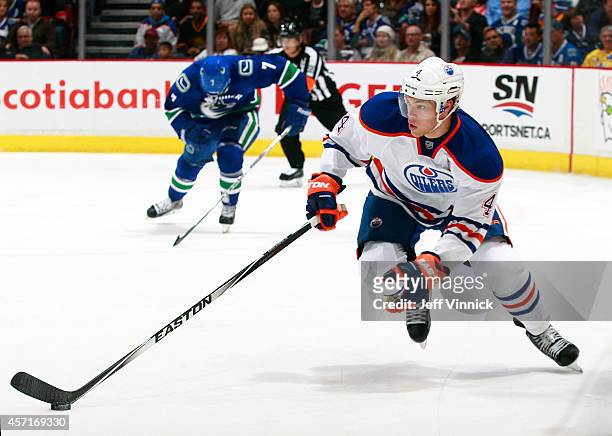 Taylor Hall of the Edmonton Oilers skates up ice with the puck during their NHL game against the Vancouver Canucks at Rogers Arena October 11, 2014...