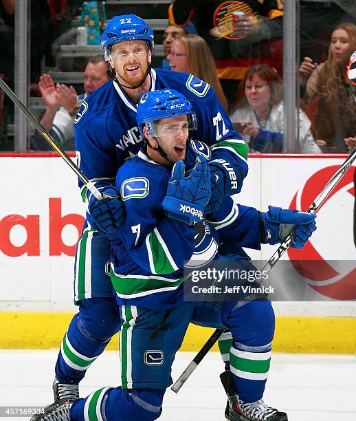 Linden Vey of the Vancouver Canucks celebrates his first NHL goal with teammate Daniel Sedin during their NHL game against the Edmonton Oilers at...