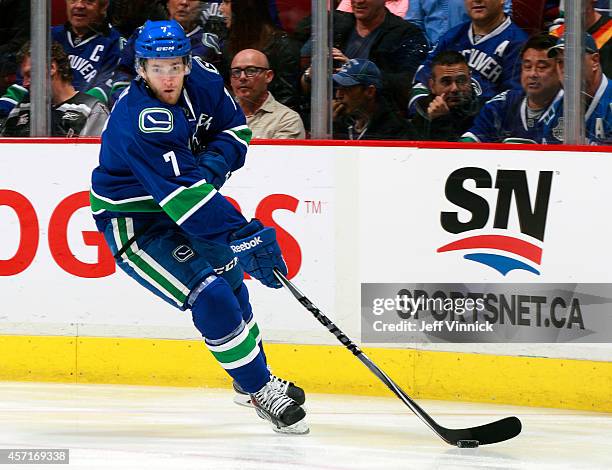 Linden Vey of the Vancouver Canucks skates up ice with the puck during their NHL game against the Edmonton Oilers at Rogers Arena October 11, 2014 in...