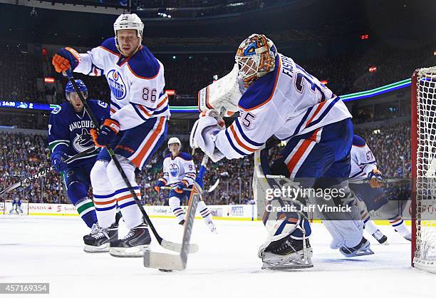 Nikita Nikitin of the Edmonton Oilers looks on as teammate Viktor Fasth plays the puck during their NHL game against the Vancouver Canucks at Rogers...