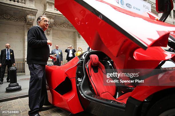 Sergio Marchionne, Chief Executive Officer, Fiat Chrysler Automobiles is viewed next to a Ferrari after ringing the Closing Bell on the floor of the...