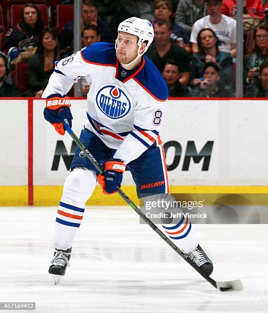 Nikita Nikitin of the Edmonton Oilers skates up ice with the puck during their NHL game against the Vancouver Canucks at Rogers Arena October 11,...