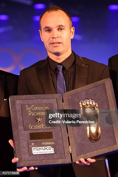 Andres Iniesta receives the Golden Foot Award trophy during the Golden Foot Award 2014 ceremony at Sporting Club on October 13, 2014 in Monte-Carlo,...