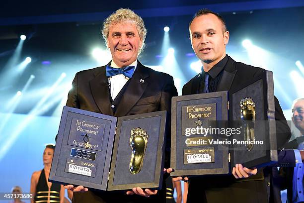 Jean-Marie Pfaff and Andres Iniesta receive the Golden Foot Award trophy during the Golden Foot Award 2014 ceremony at Sporting Club on October 13,...