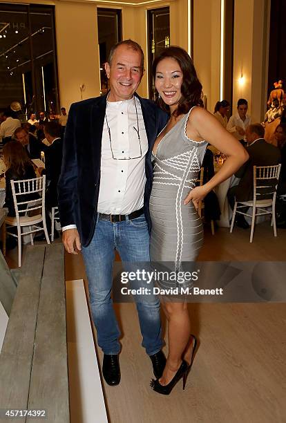 David Grob and Olyvia Kwok attend the launch party for Phillips European Headquarters at 30 Berkeley Square on October 13, 2014 in London, England.