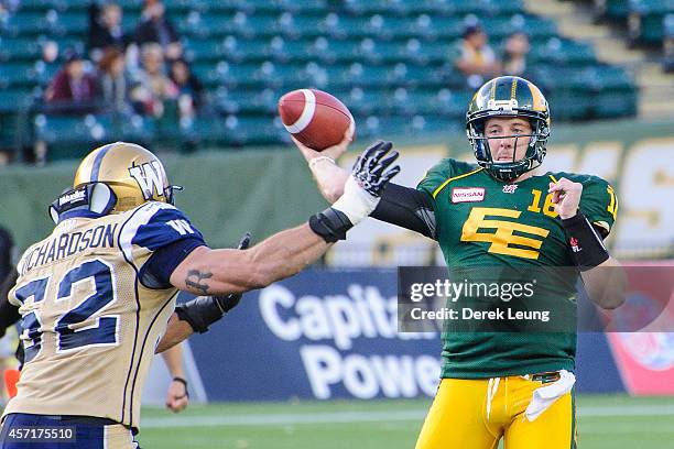 Matt Nichols of the Edmonton Eskimos makes a pass before Louie Richardson of the Winnipeg Blue Bombers can stop him during a CFL game at Commonwealth...