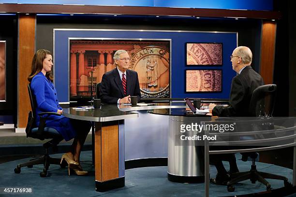 Minority Leader U.S. Sen. Mitch McConnell and Kentucky Secretary of State Alison Lundergan Grimes prepare with host Bill Goodman before their debate...