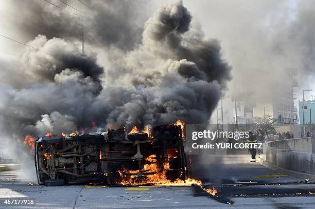 View of a blazing car after students set the Municipal Palace on fire in Chilpancingo, Guerrero on October 13 during a protest to demand the finding...