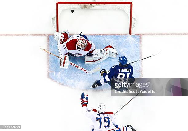 Steven Stamkos of the Tampa Bay Lightning shoots the puck through the legs of goalie Carey Price of the Montreal Canadiens for a goal after out...