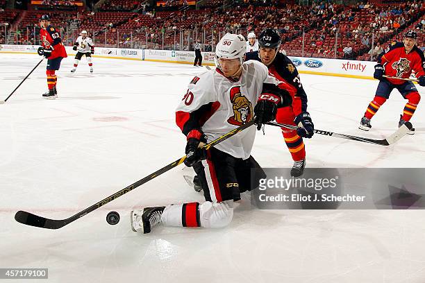 Alex Chiasson of the Ottawa Senators attempts to control the puck against Willie Mitchell of the Florida Panthers during the second period at the...