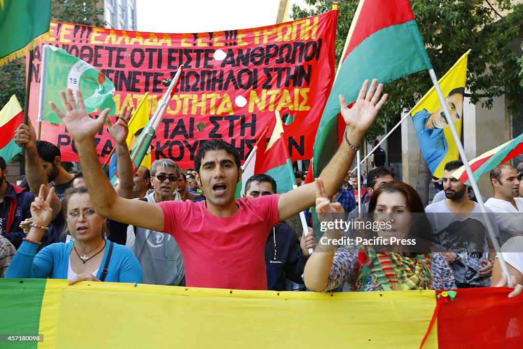 Kurdish protesters march through Athens, shouting slogans...