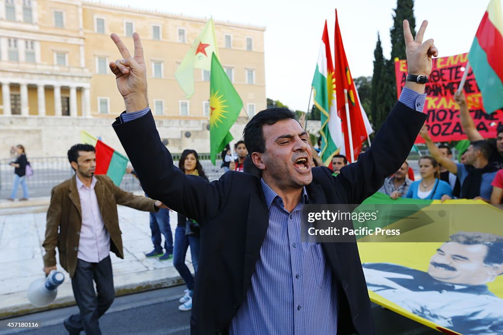 A protester shouts slogans  while making a "peace" sign...