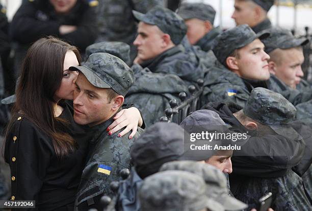 Soldier of Ukrainian National Guard and his girlfriend take part in a demonstration outside of the presidential administration office in Kiev,...