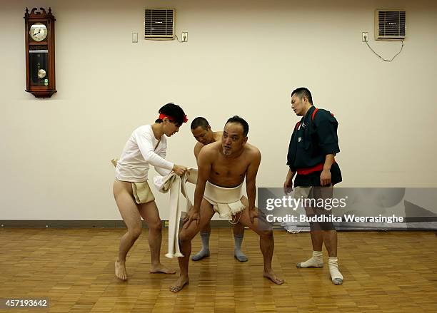 Japanese Shrine Parishioners of the Matsubara team put on Fundoshi, or loincloths as they prepare during the first day of Nada Fighting Festival on...