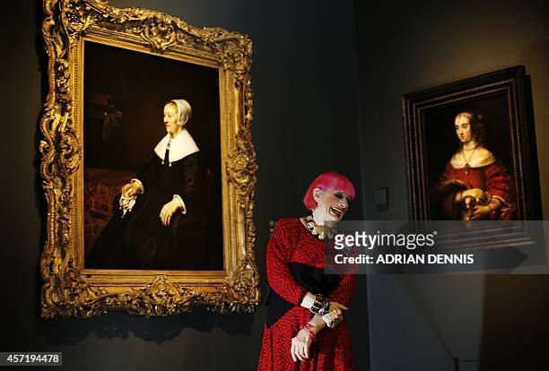 British fashion designer Zandra Rhodes is pictured in front of a painting entitled 'Portrait of Catrina Hooghsaet' by Dutch artist Rembrandt, during...