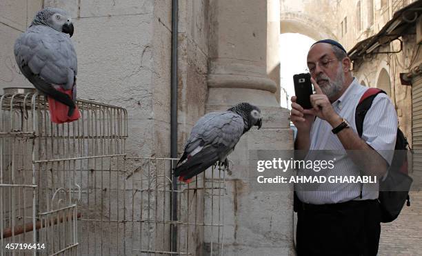 An Orthodox Jewish man takes a photo for Parrot in the old city in Jerusalem on October 14, 2014. The Israeli cabinet last week sent the 2015 budget...