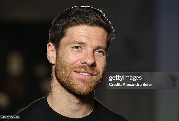 Bayern Muenchen player Xabi Alonso gives an interview during his visit at the FC Bayern Erlebniswelt museum at Allianz Arena on October 14, 2014 in...