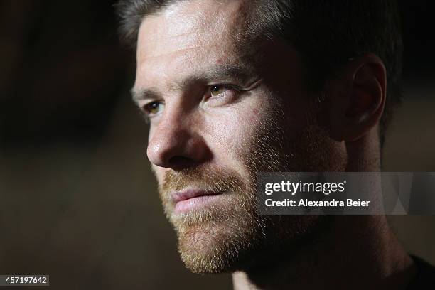 Bayern Muenchen player Xabi Alonso gives an interview during his visit at the FC Bayern Erlebniswelt museum at Allianz Arena on October 14, 2014 in...