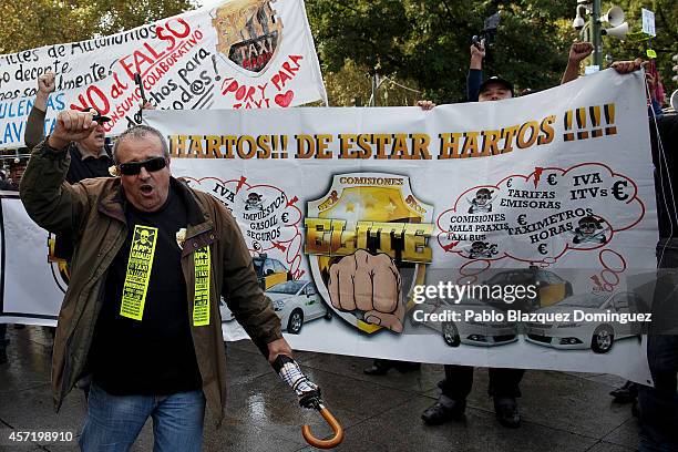 Taxi drivers protest against new private cab 'UBER' application on October 14, 2014 in Madrid, Spain. 'Uber' application started to operate in Madrid...