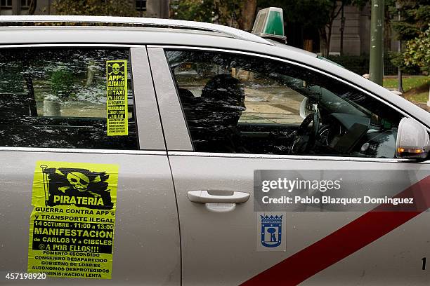 Taxi driver drives his car during a protest against new private cab 'UBER' application on October 14, 2014 in Madrid, Spain. 'Uber' application...