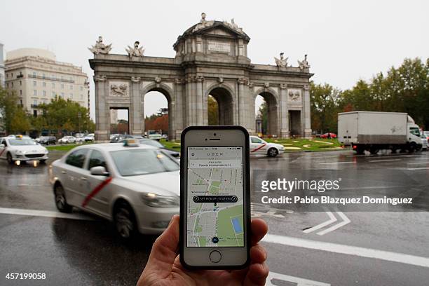 In this photo illustration the new smart phone taxi app 'Uber' shows how to select a pick up location at Puerta de Alcala Square on October 14, 2014...