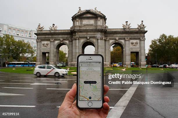 In this photo illustration the new smart phone taxi app 'Uber' shows how to select a pick up location at Puerta de Alcala Square on October 14, 2014...