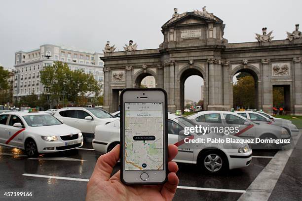 In this photo illustration the new smart phone taxi app 'Uber' shows how to select a pick up location at Puerta de Alcala Square on October 14, 2014...