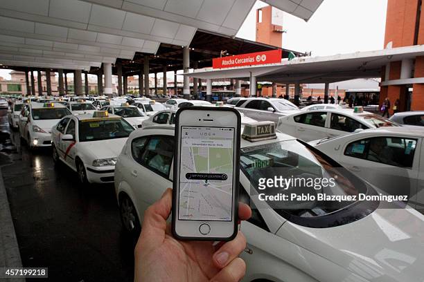 In this photo illustration the new smart phone taxi app 'Uber' shows how to select a pick up location at Atocha Station on October 14, 2014 in...