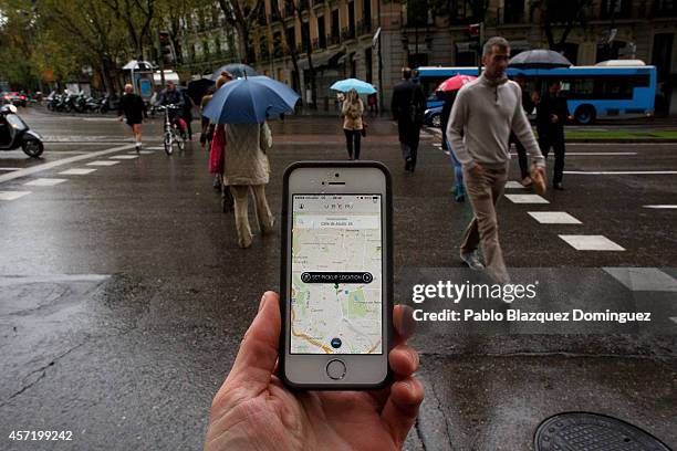 In this photo illustration the new smart phone taxi app 'Uber' shows how to select a pick up location at Puerta de Alcala Square on October 14, 2014...